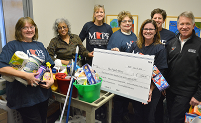 MAPE locals present check and cleaning supplies to the Family Place.